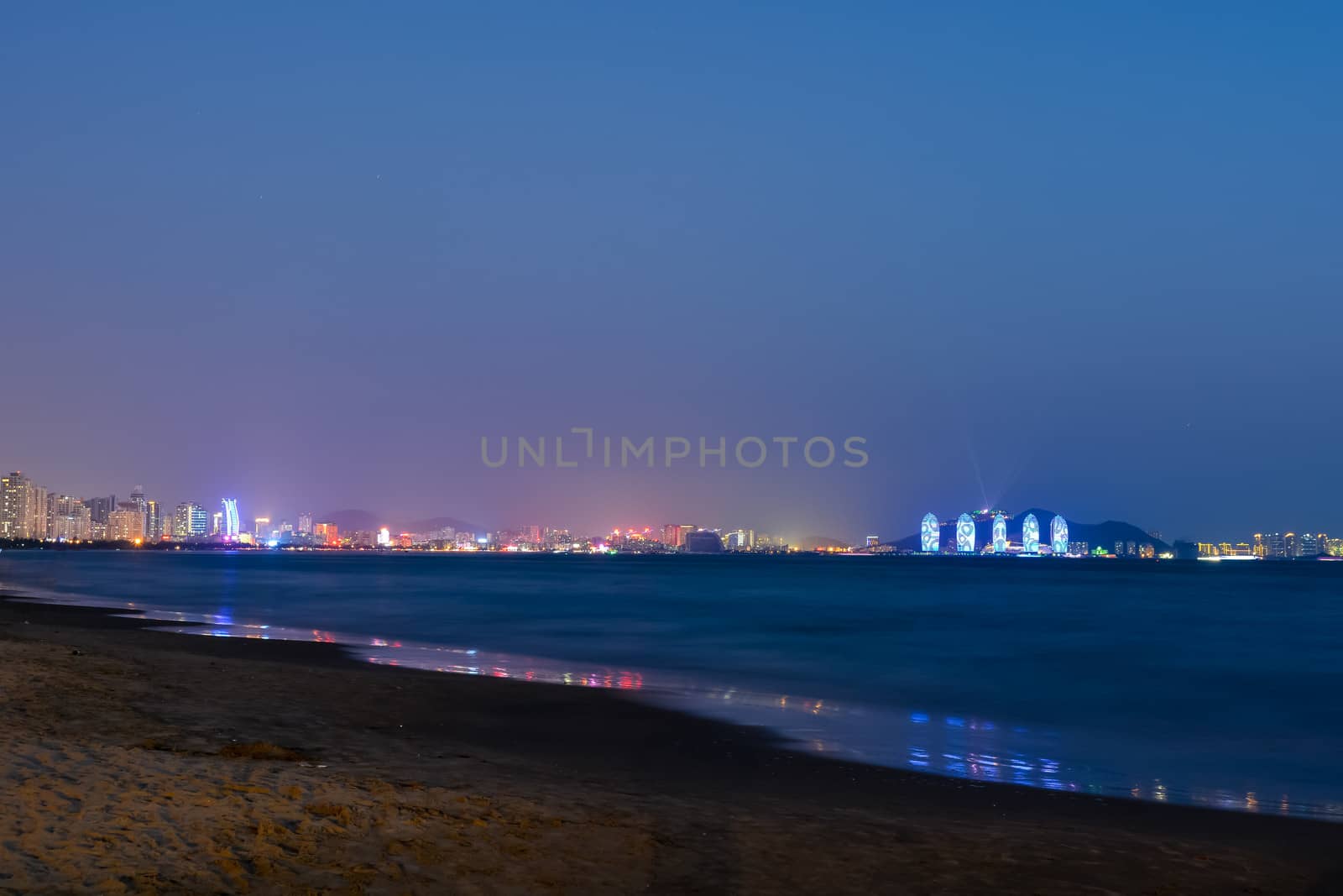 The Sanya bay beach under the sunset.