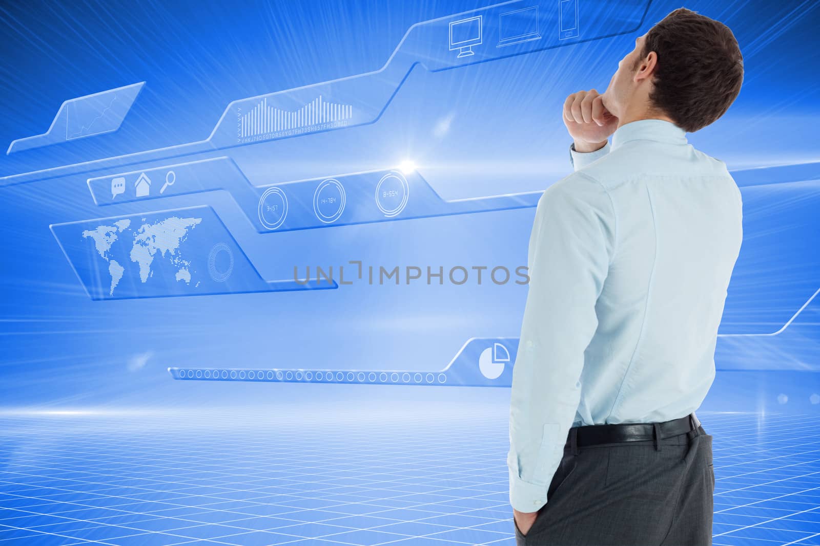 Thoughtful businessman with hand on chin against futuristic technology interface
