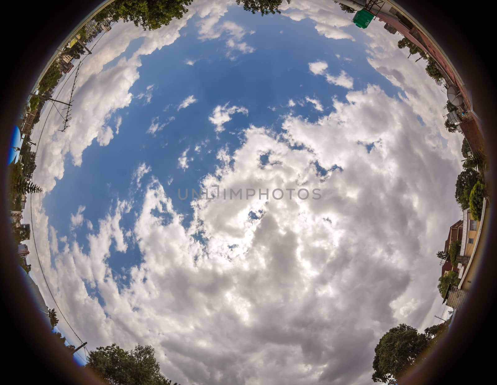 Circular fish eye image of the clouds wth a blue sky