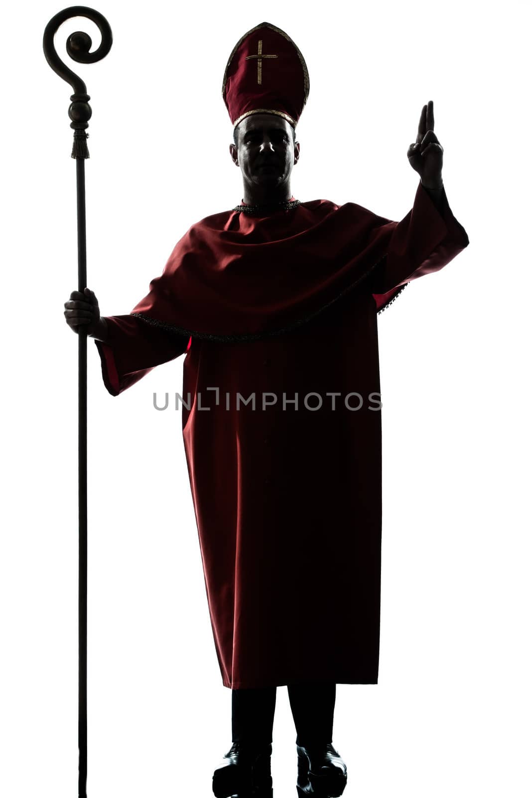 one man cardinal bishop silhouette saluting blessing in studio isolated on white background