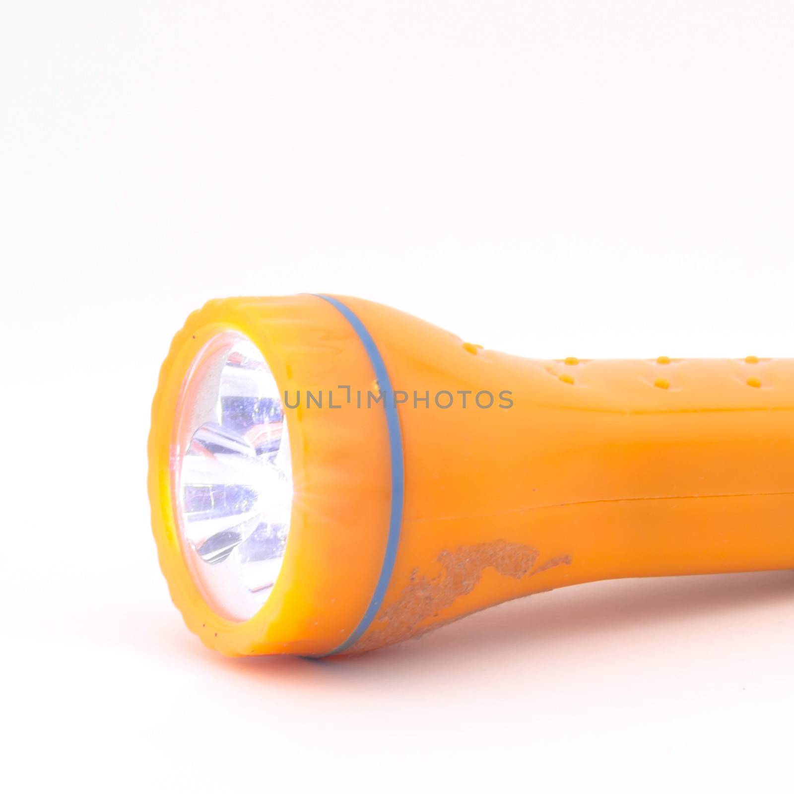 orange flashlight isolated on white background