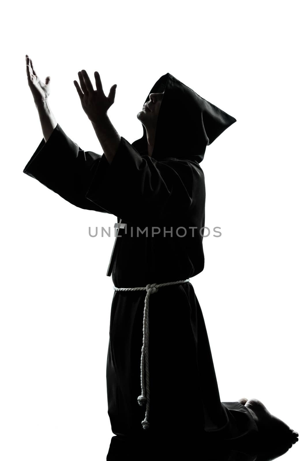 one caucasian man priest praying silhouette in studio isolated on white background