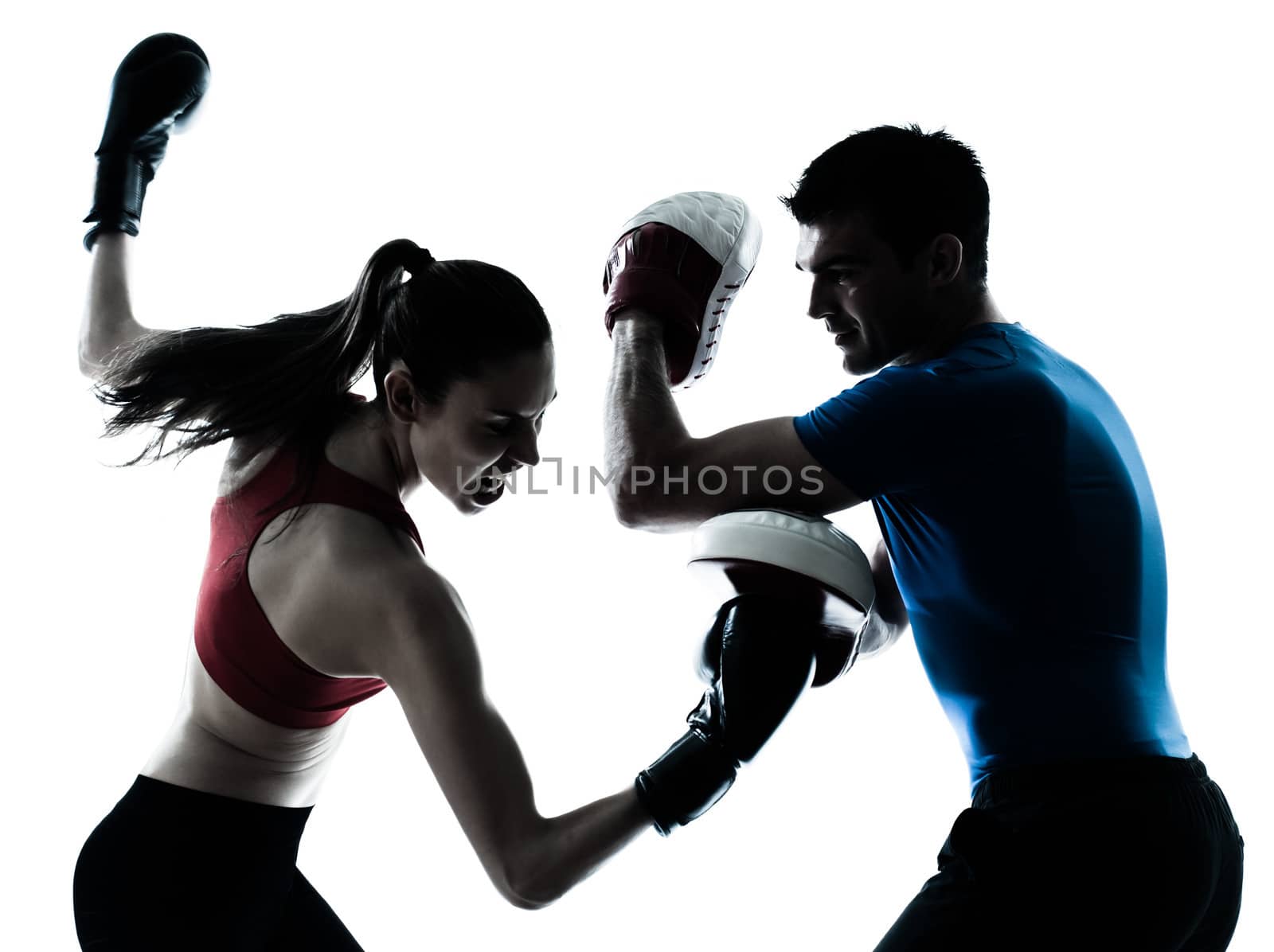 personal trainer man coach and woman exercising boxing silhouette studio isolated on white background