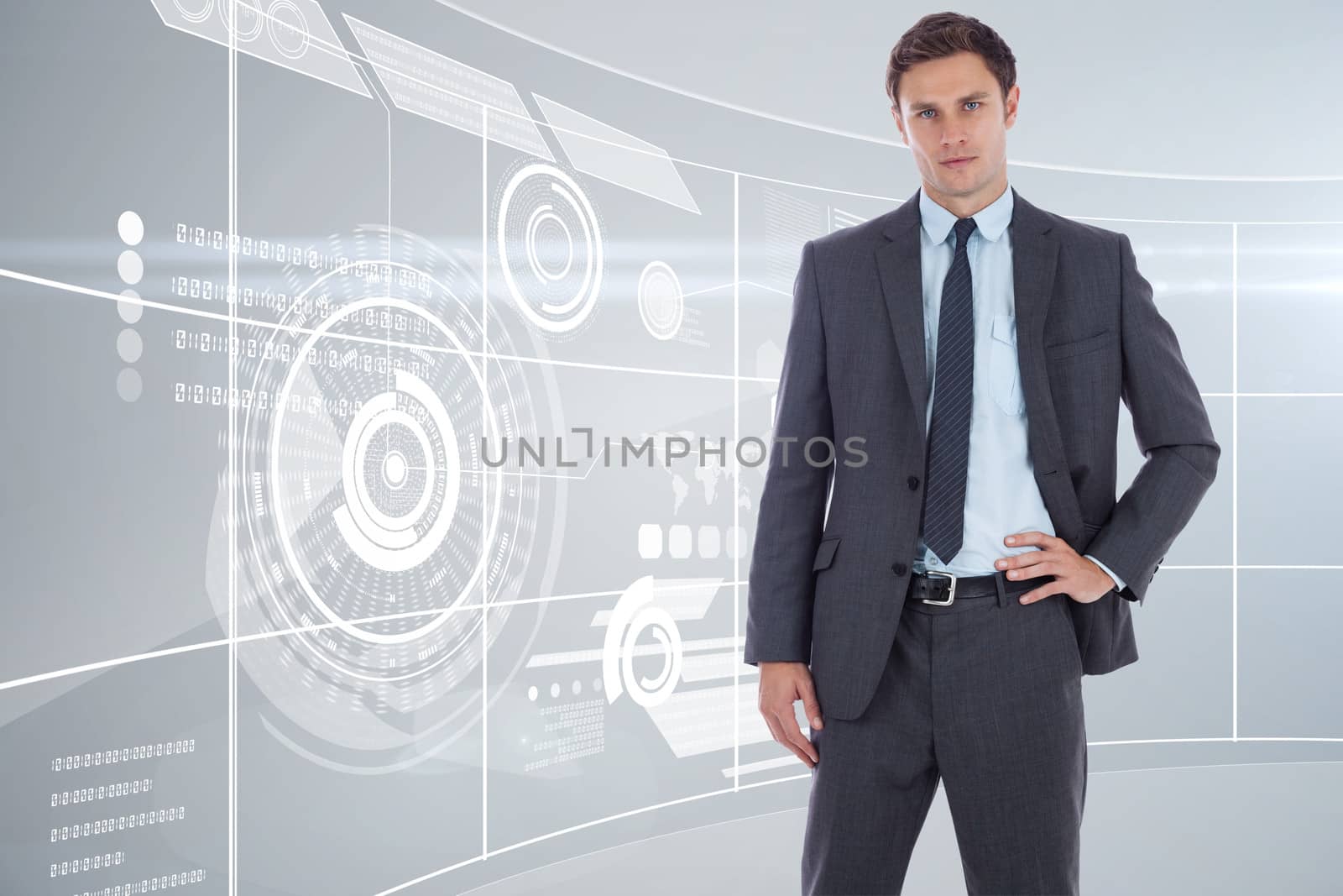 Serious businessman with hand on hip against futuristic technology interface