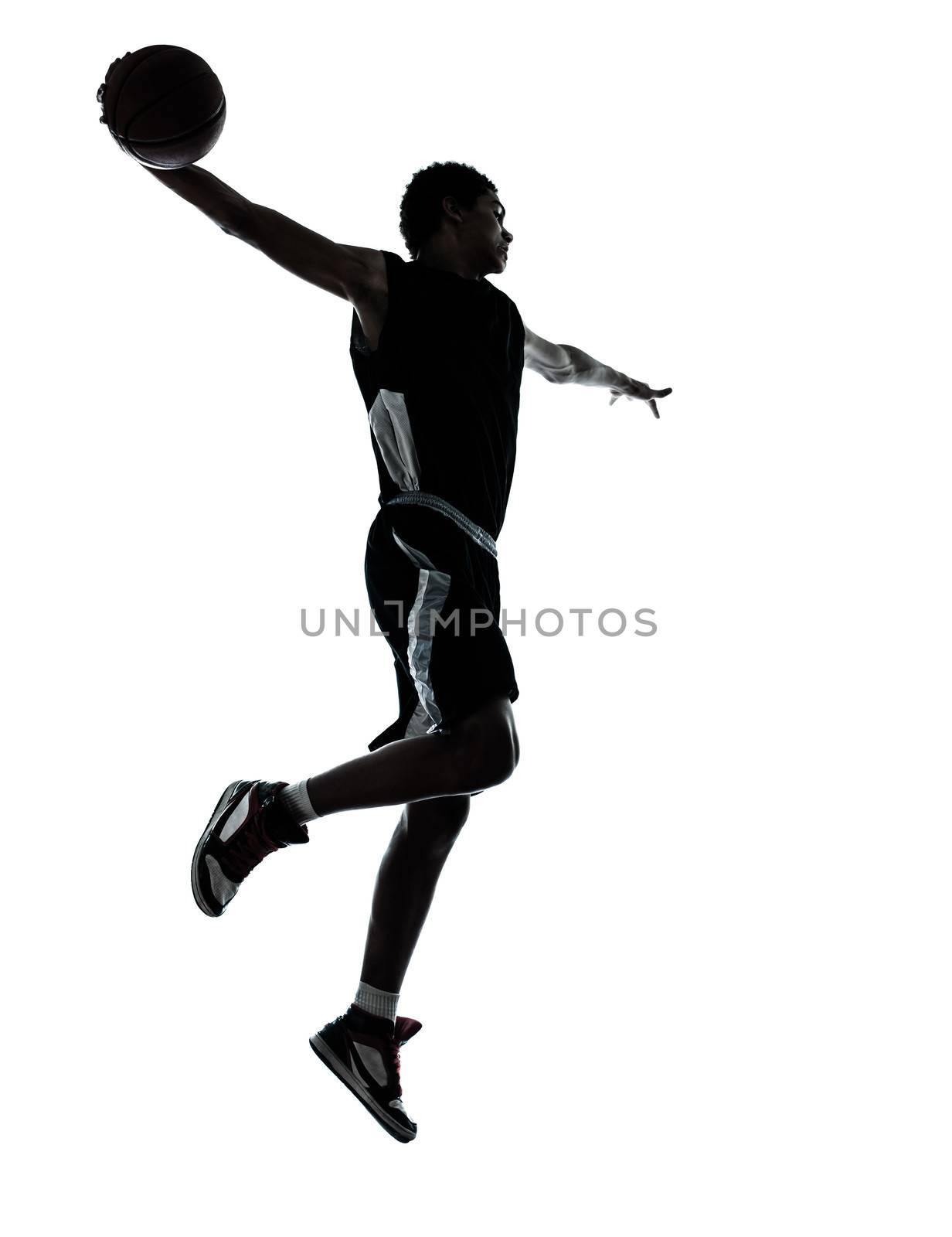 one young man basketball player silhouette in studio isolated on white background