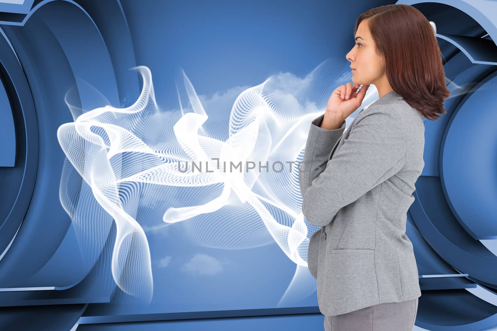 Concentrating businesswoman against abstract linear design in blue and white