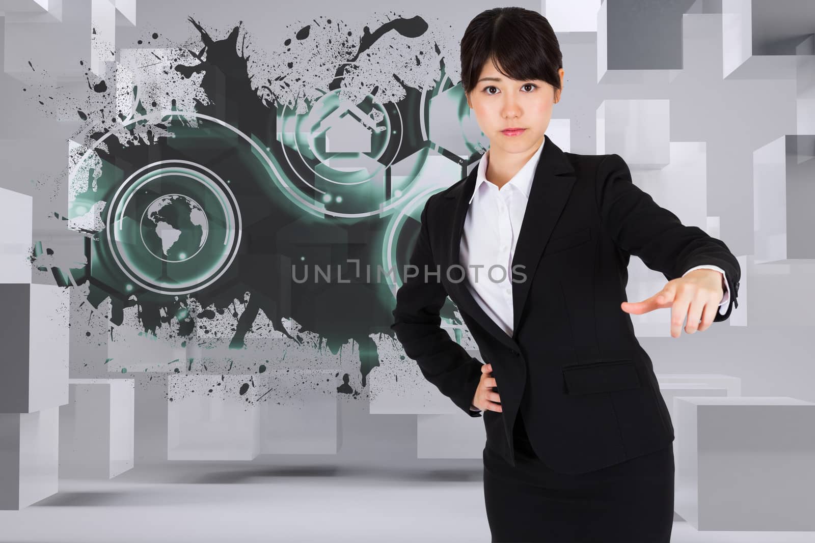 Focused businesswoman pointing against splash showing technology interface