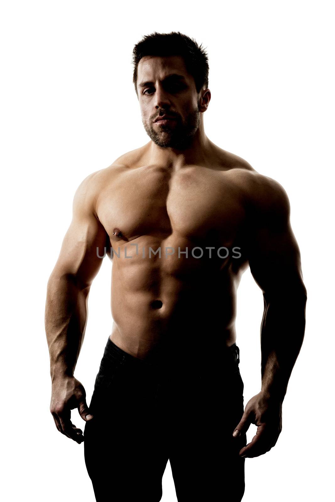 A handsome muscular sports man hard lit with deep shadows isolated on a white background