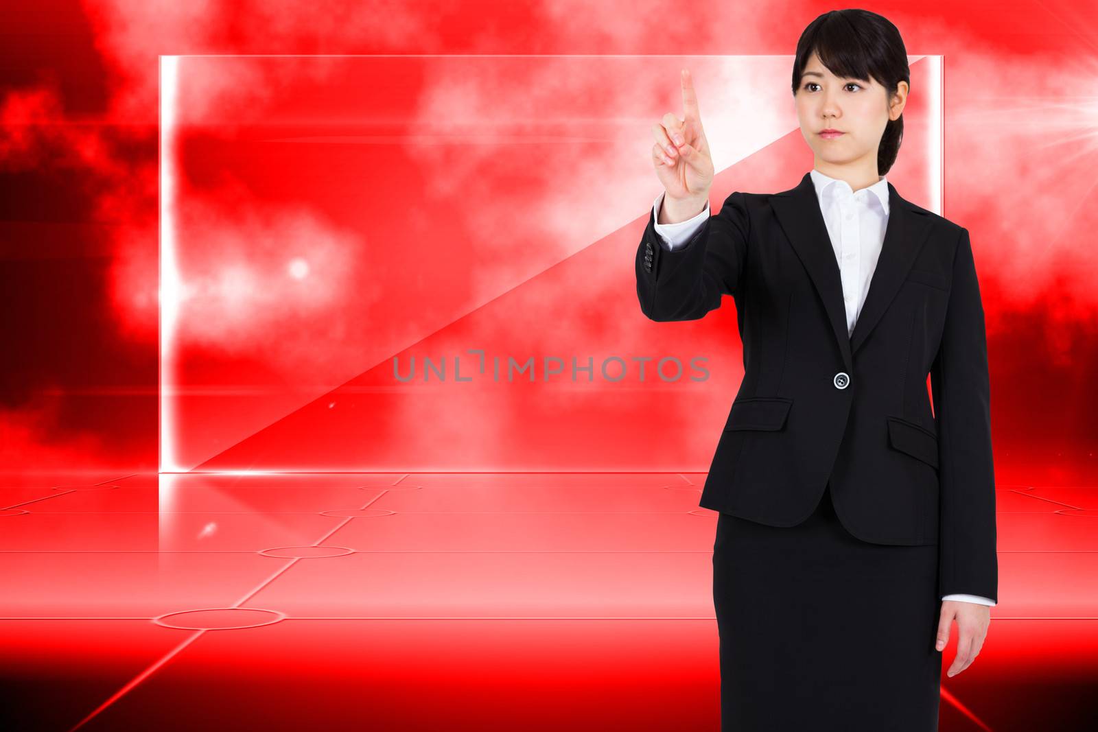 Focused businesswoman pointing against futuristic technology interface