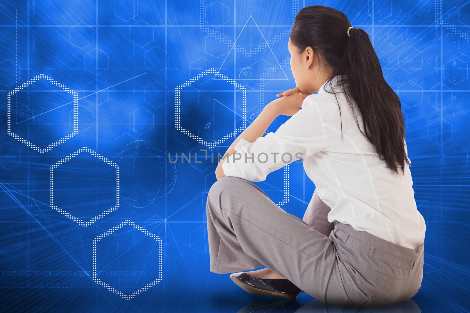 Businesswoman sitting cross legged against abstract technology background