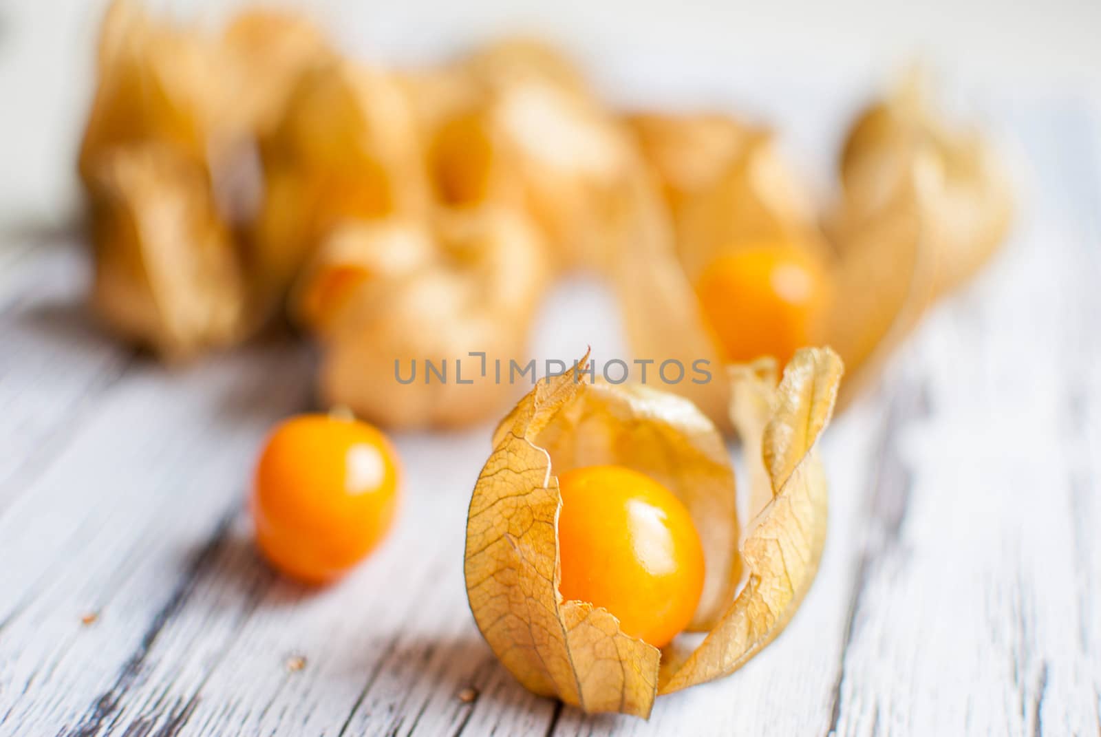 ripe healthy orange physalis over wooden board