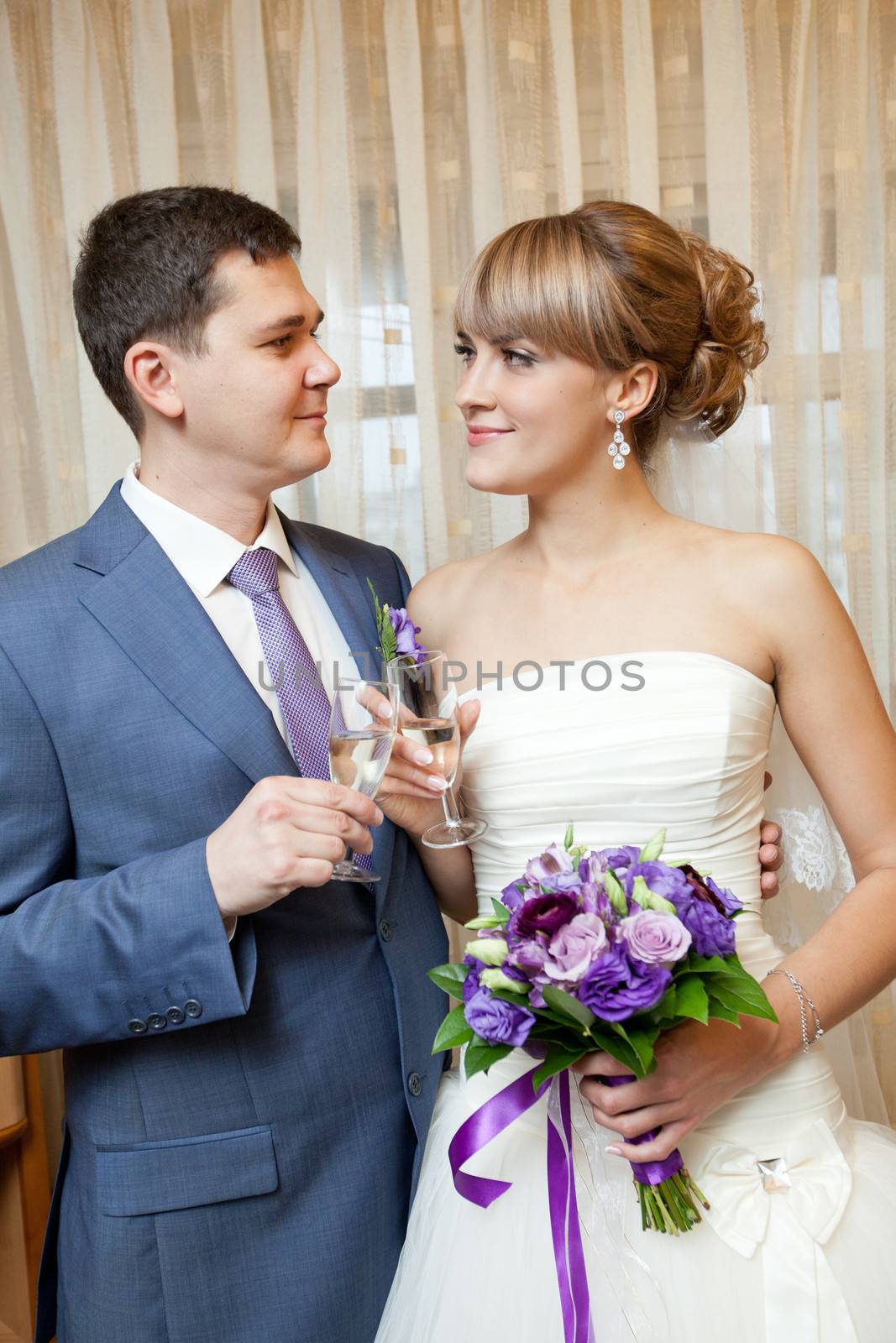 bride and groom with champagne by vsurkov