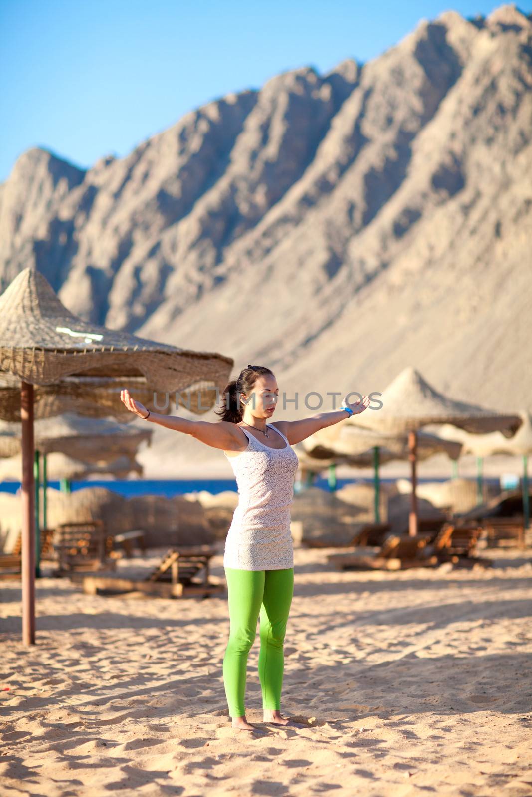 girl meditating on the beach by vsurkov