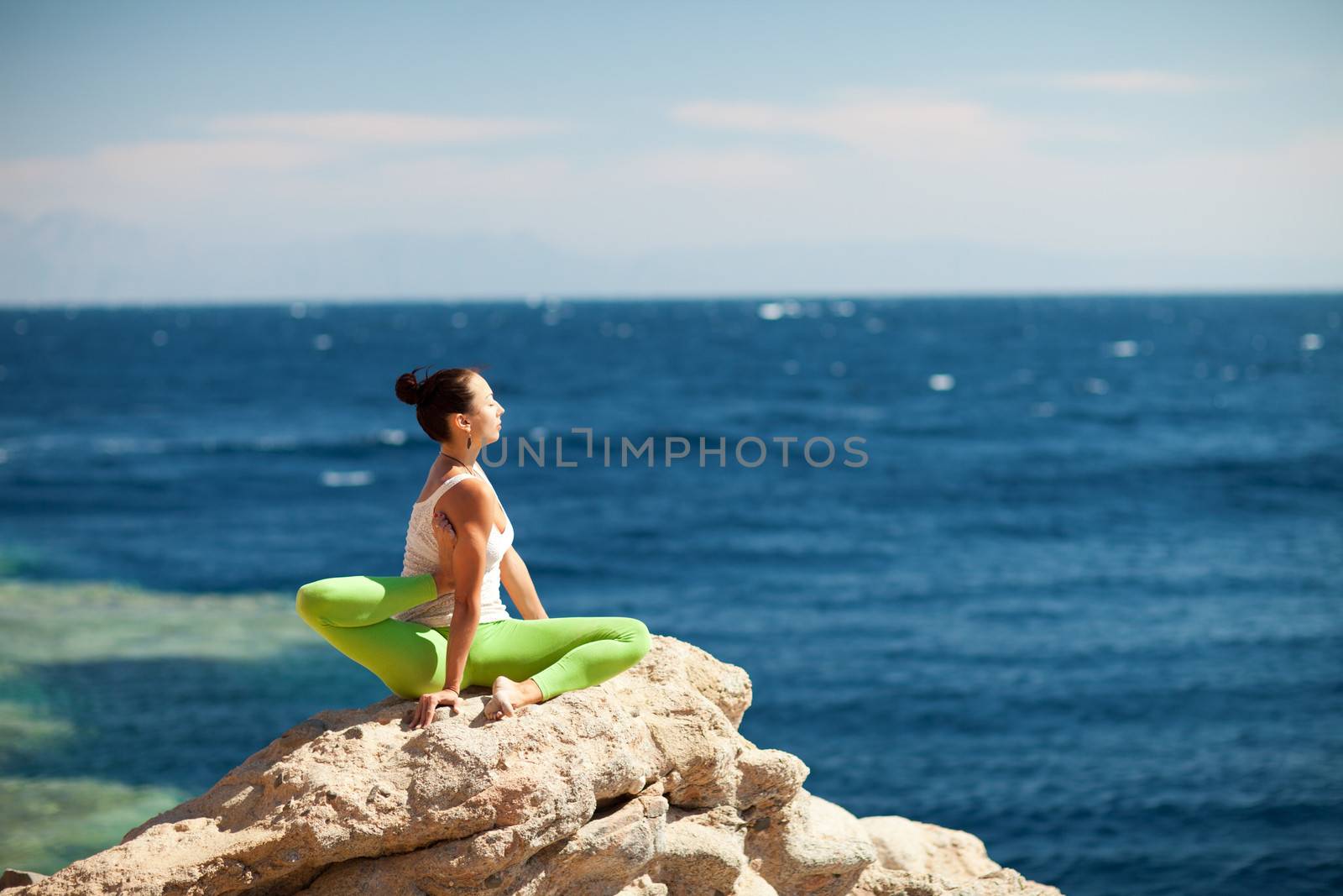 girl doing yoga on the beach by vsurkov
