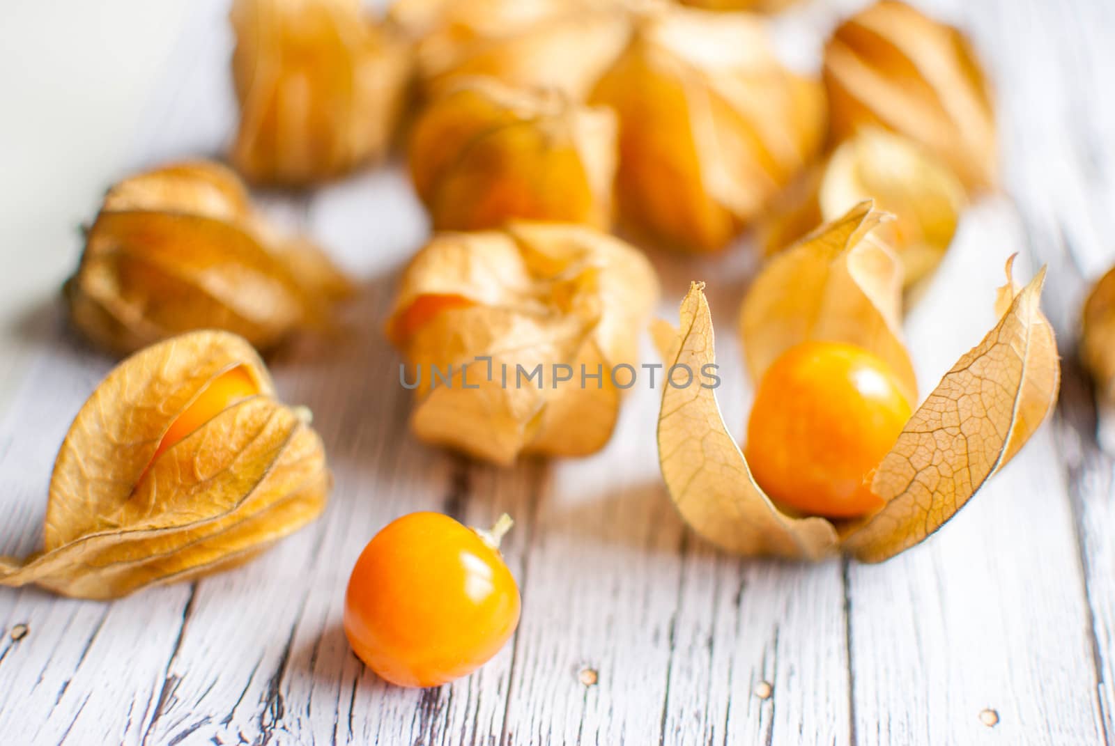 ripe healthy orange physalis over wooden board