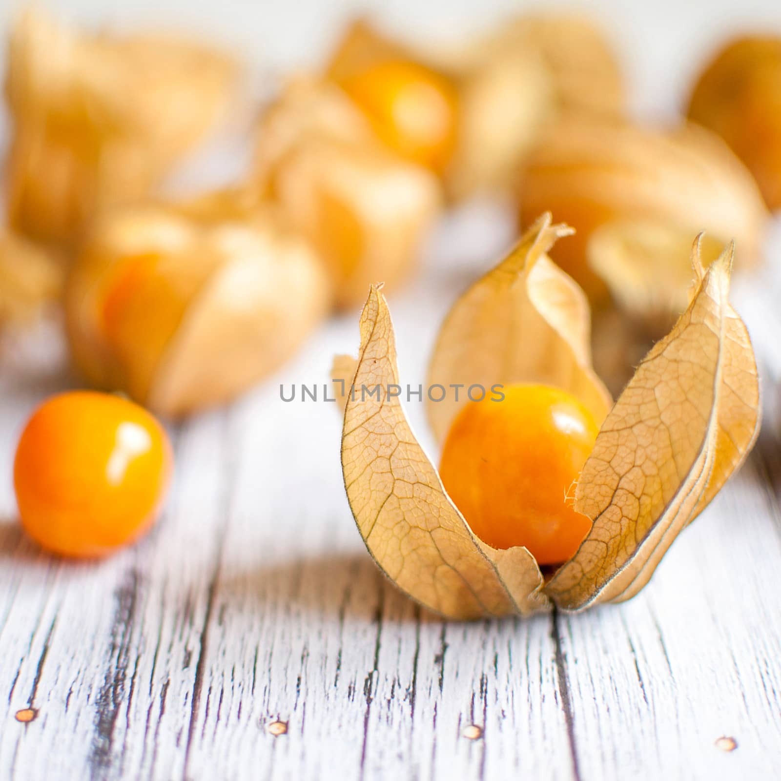 ripe healthy orange physalis over wooden board