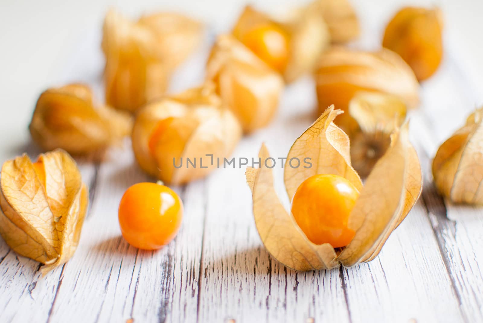 ripe healthy orange physalis over wooden board