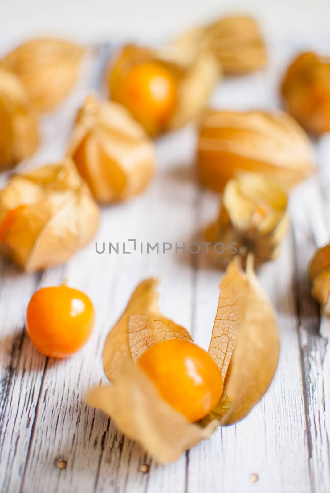 ripe healthy orange physalis over wooden board