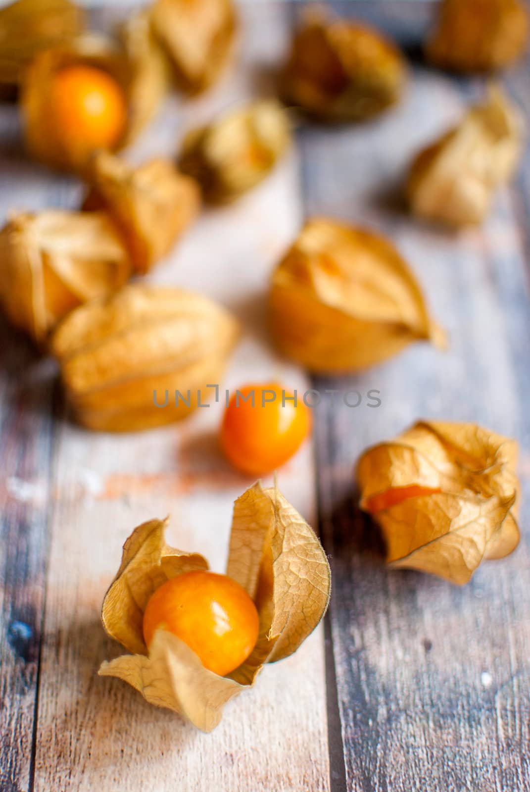 ripe healthy orange physalis over wooden board