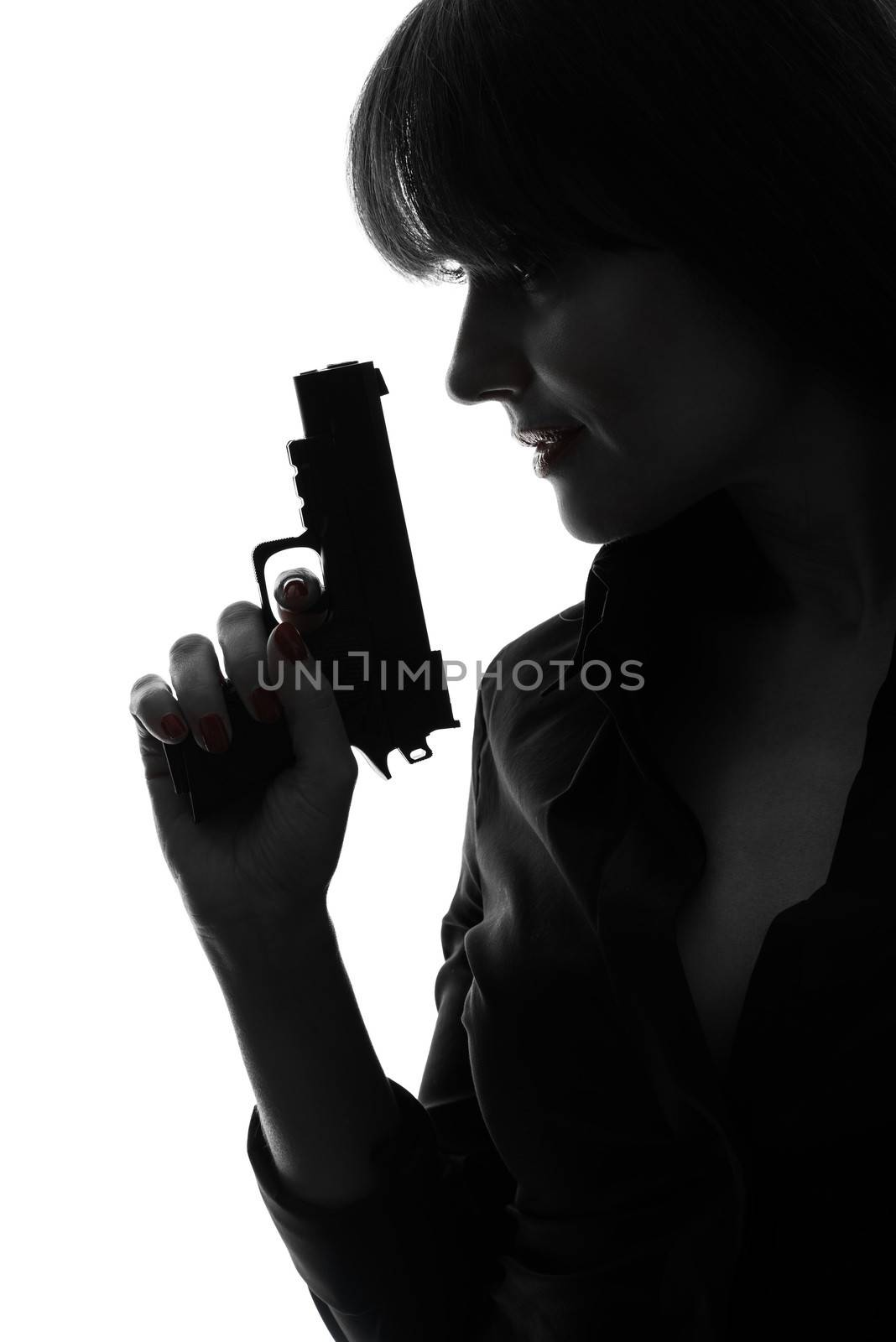 one caucasian sexy detective woman holding aiming gun in silhouette studio isolated on white background