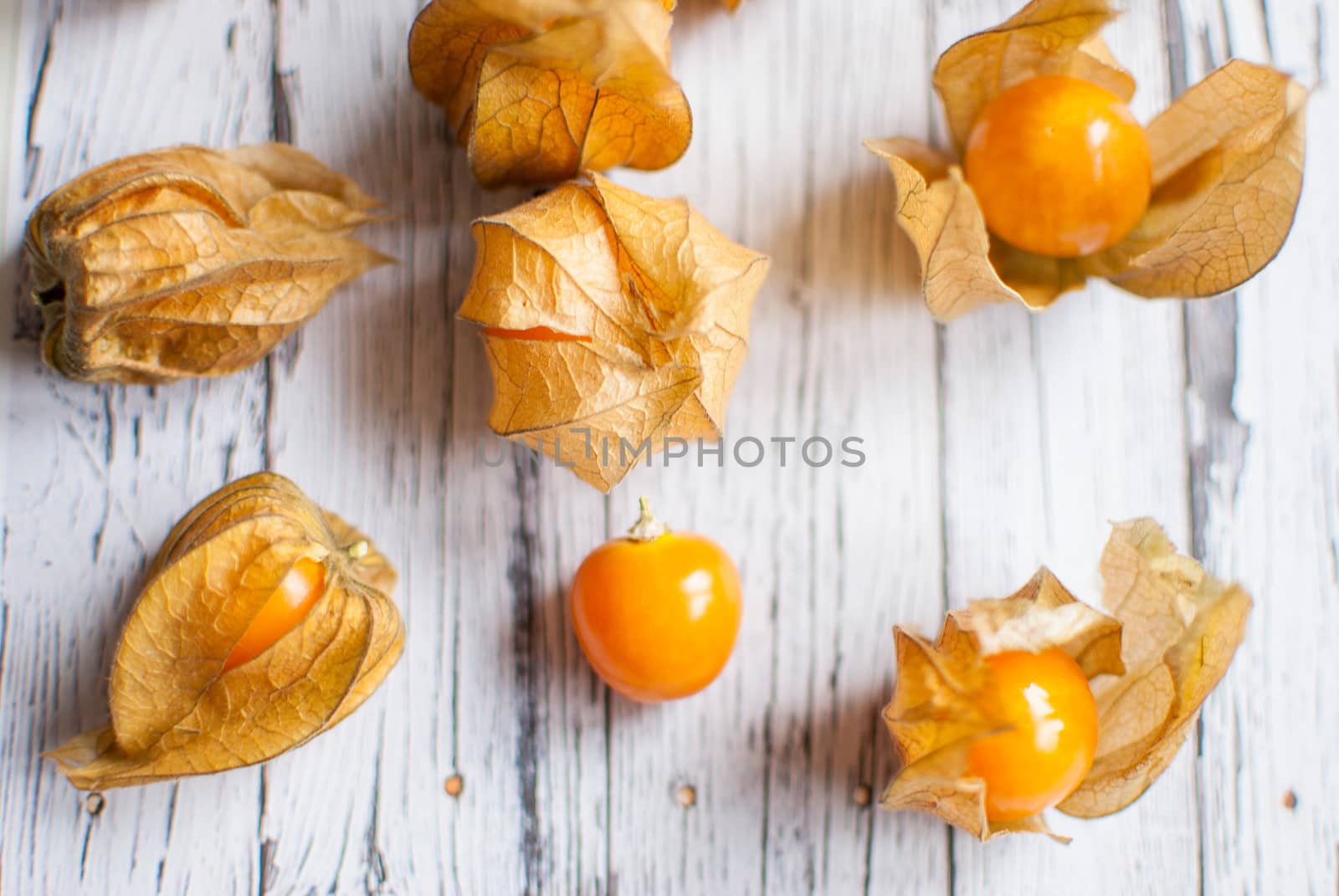 ripe healthy orange physalis over wooden board