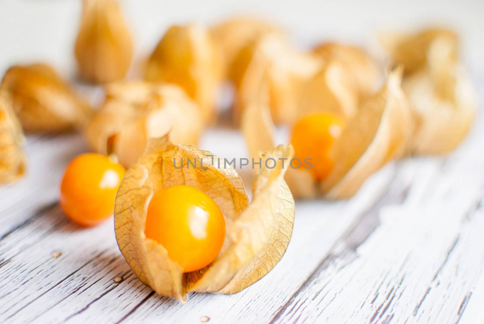 ripe healthy orange physalis over wooden board