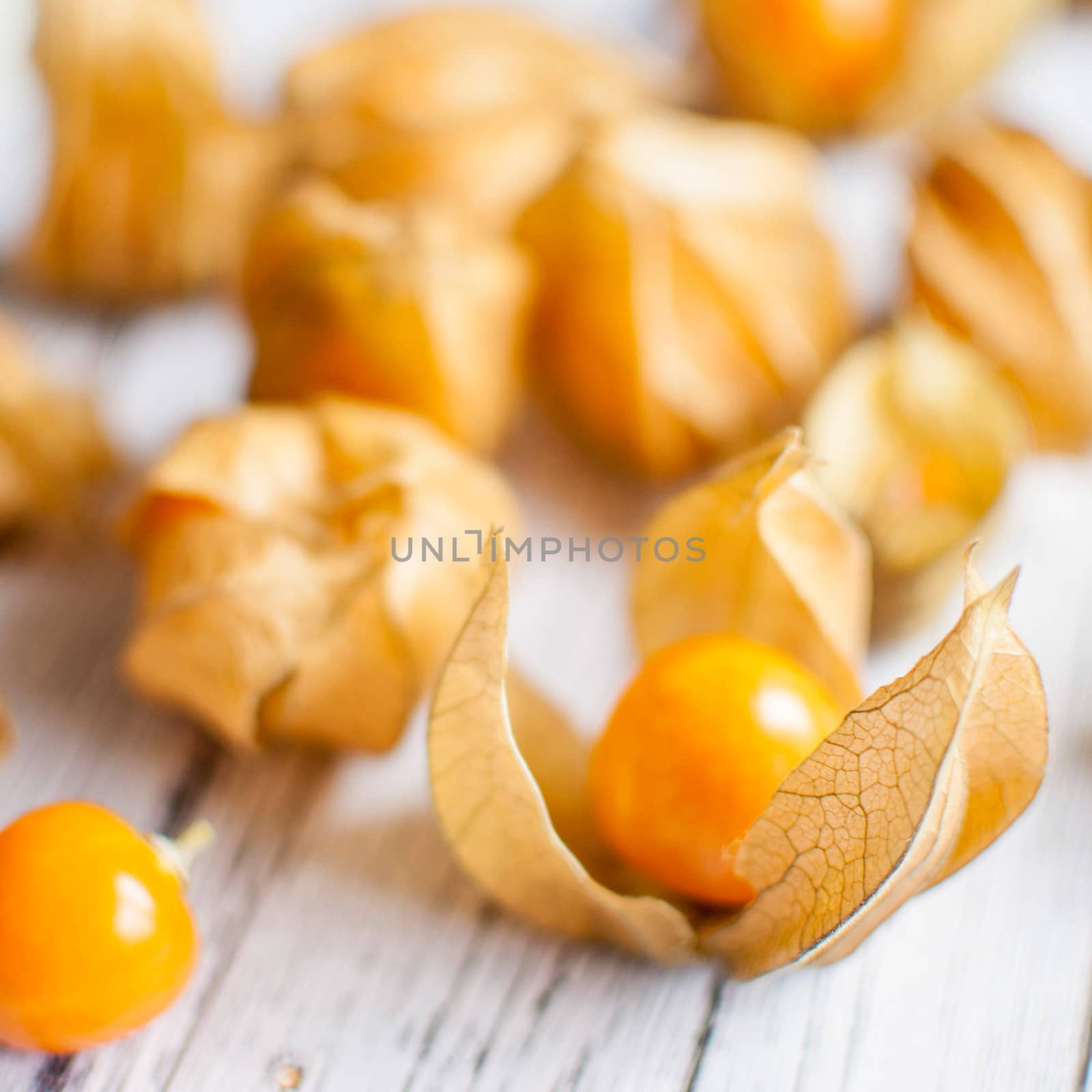 ripe healthy orange physalis over wooden board