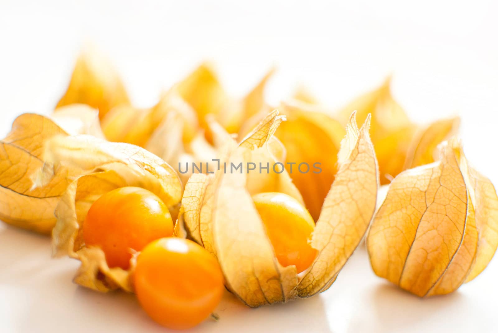 ripe healthy orange physalis over wooden board