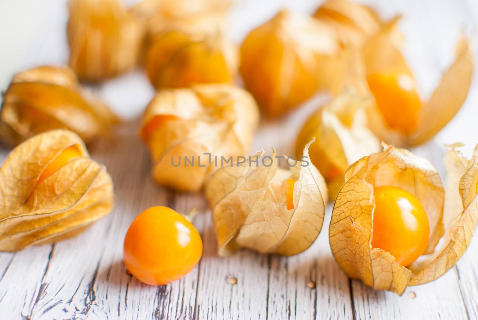 ripe healthy orange physalis over wooden board