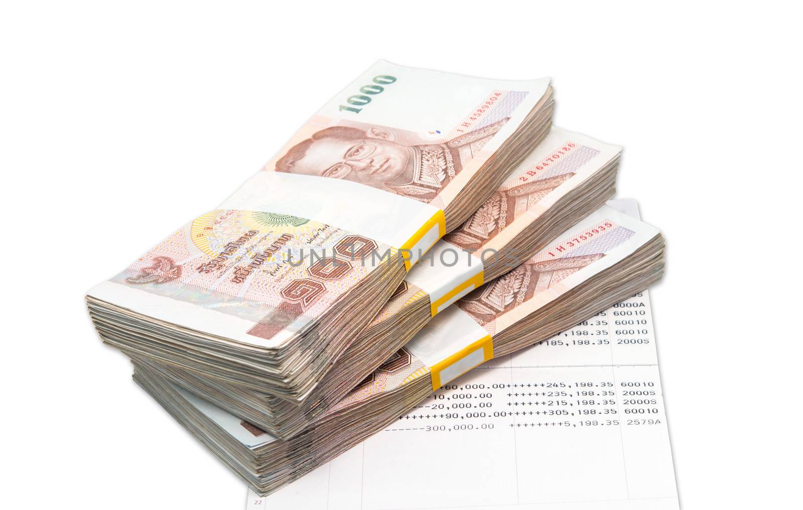Stacks of 1000 baht bills on account book isolated white background