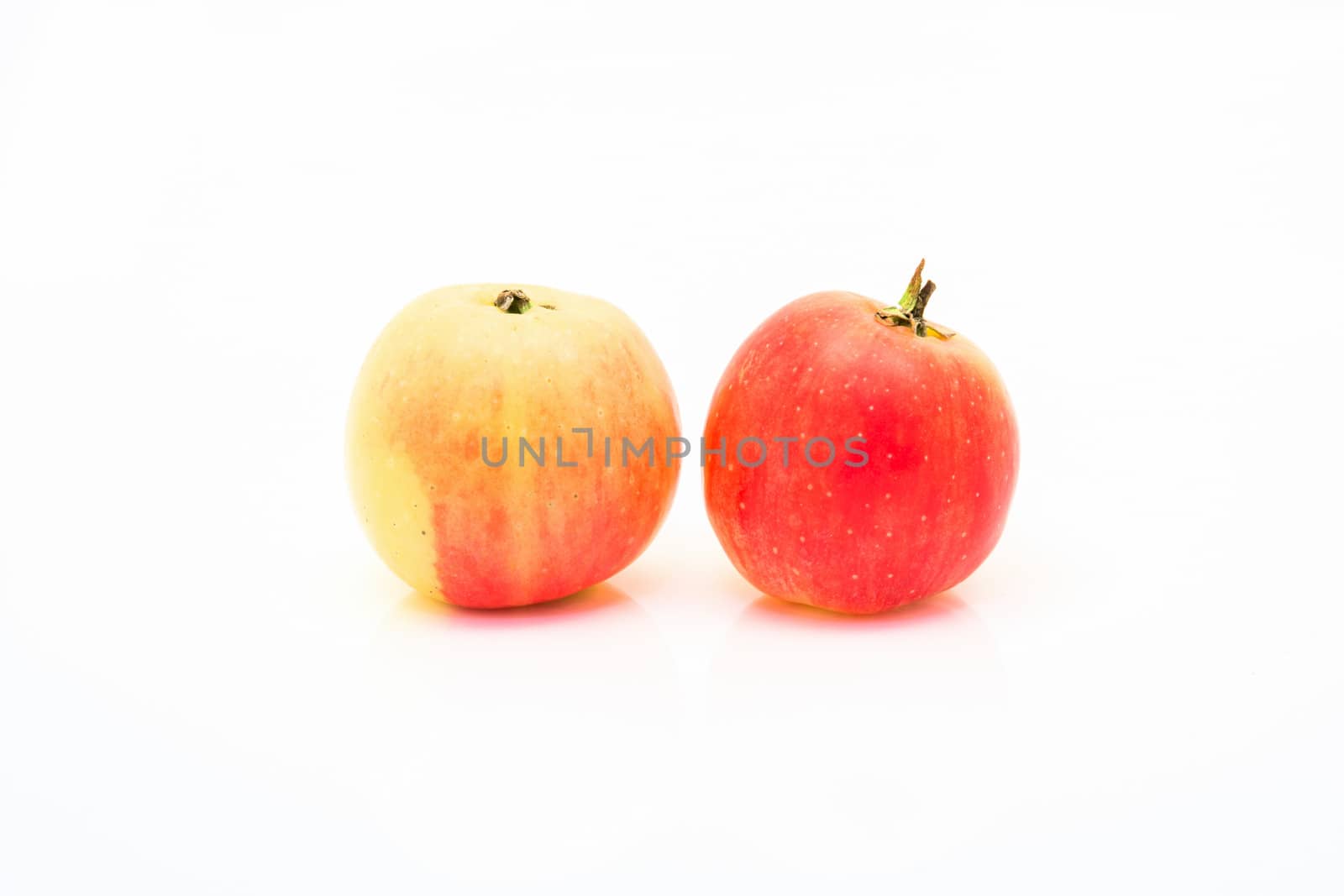 small red and yellow apples isolated by Sorapop