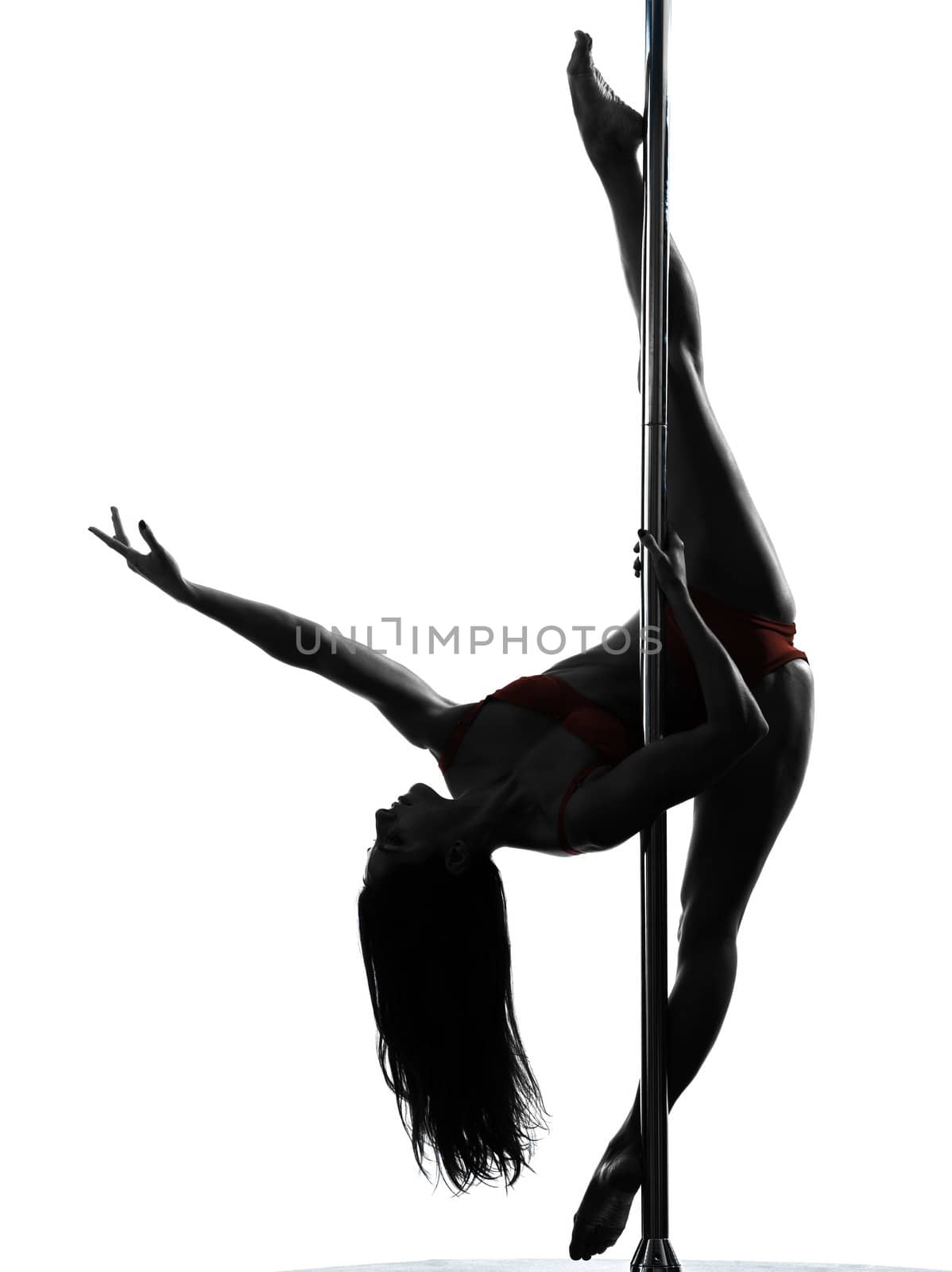 one caucasian woman pole dancer dancing in silhouette studio isolated on white background