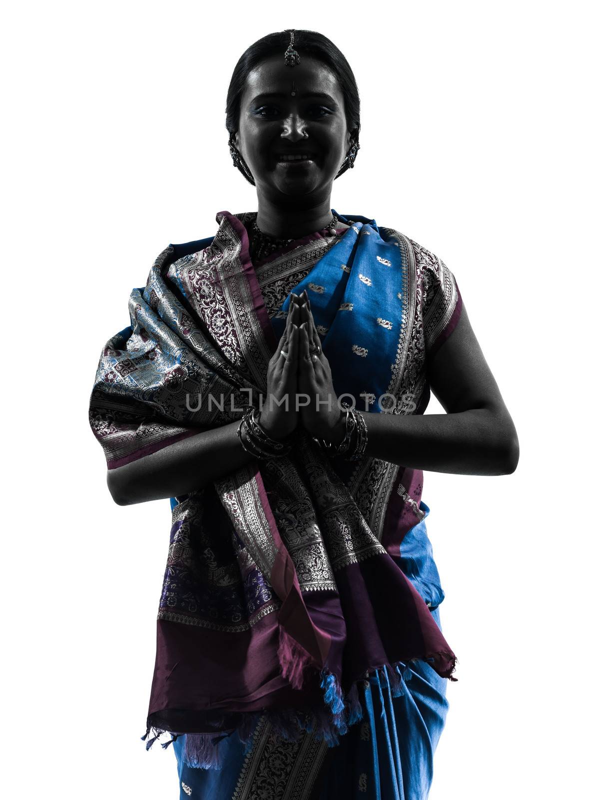 one indian woman saluting praying in silhouette studio isolated on white background