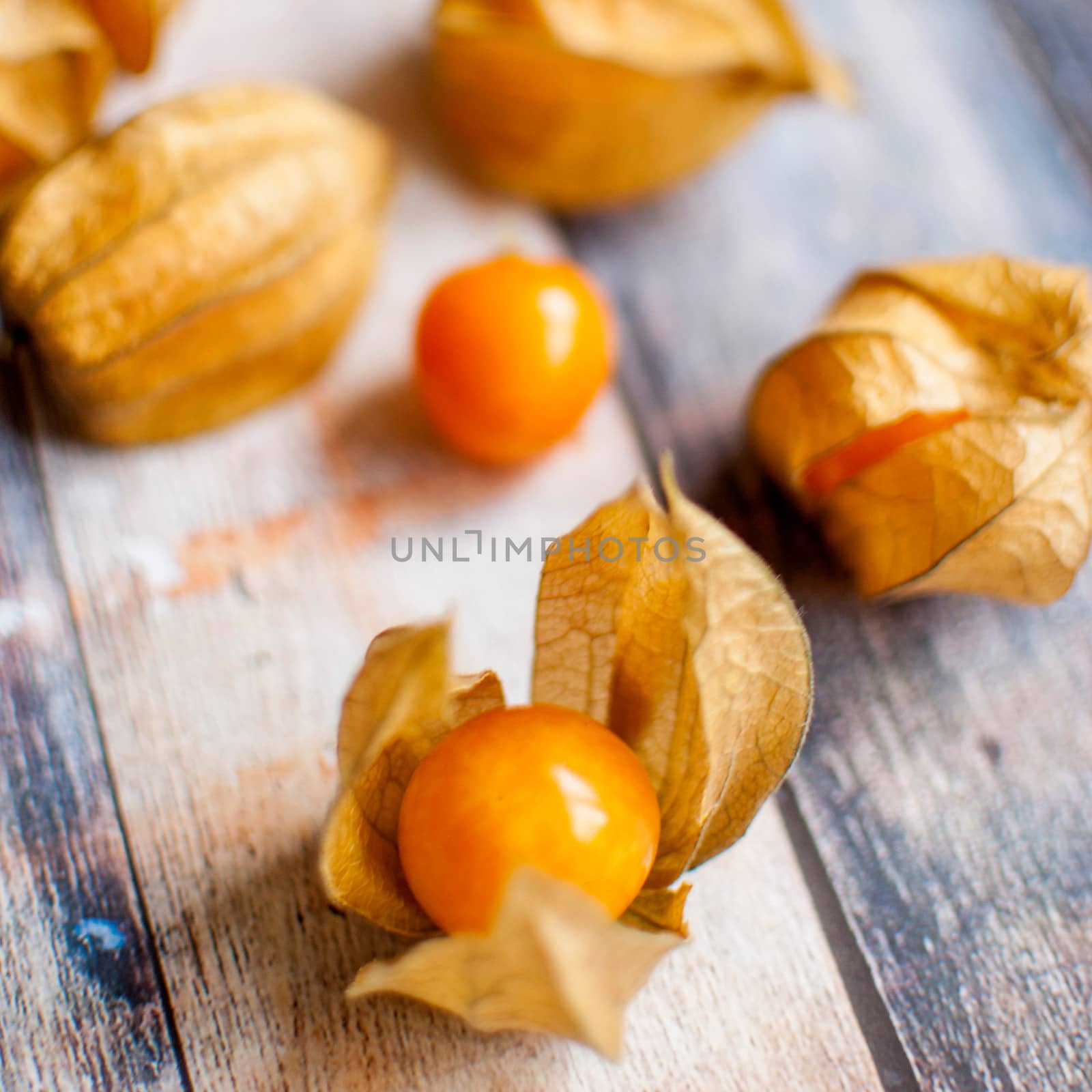 ripe healthy orange physalis over wooden board