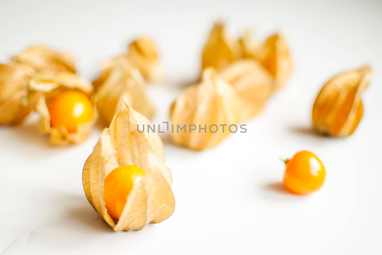 ripe healthy orange physalis over wooden board