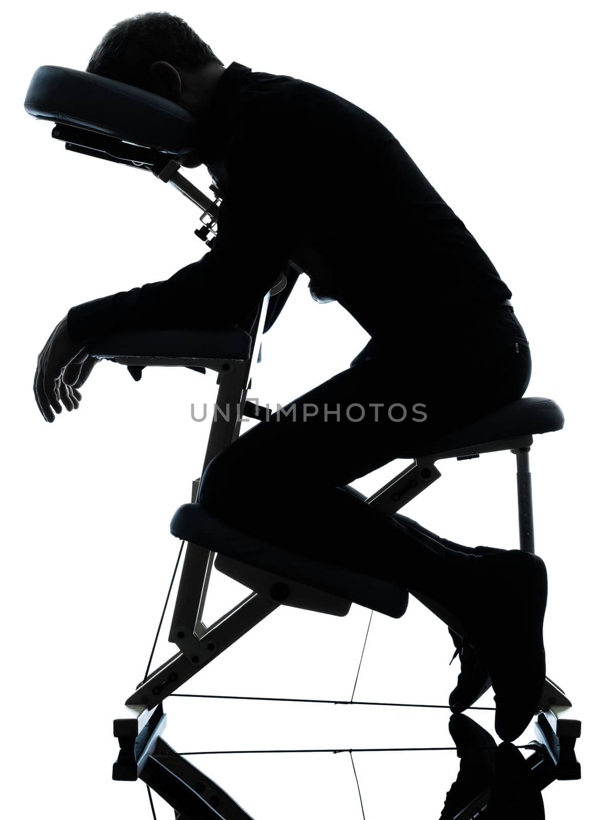 one man on chair massage in silhouette studio on white background