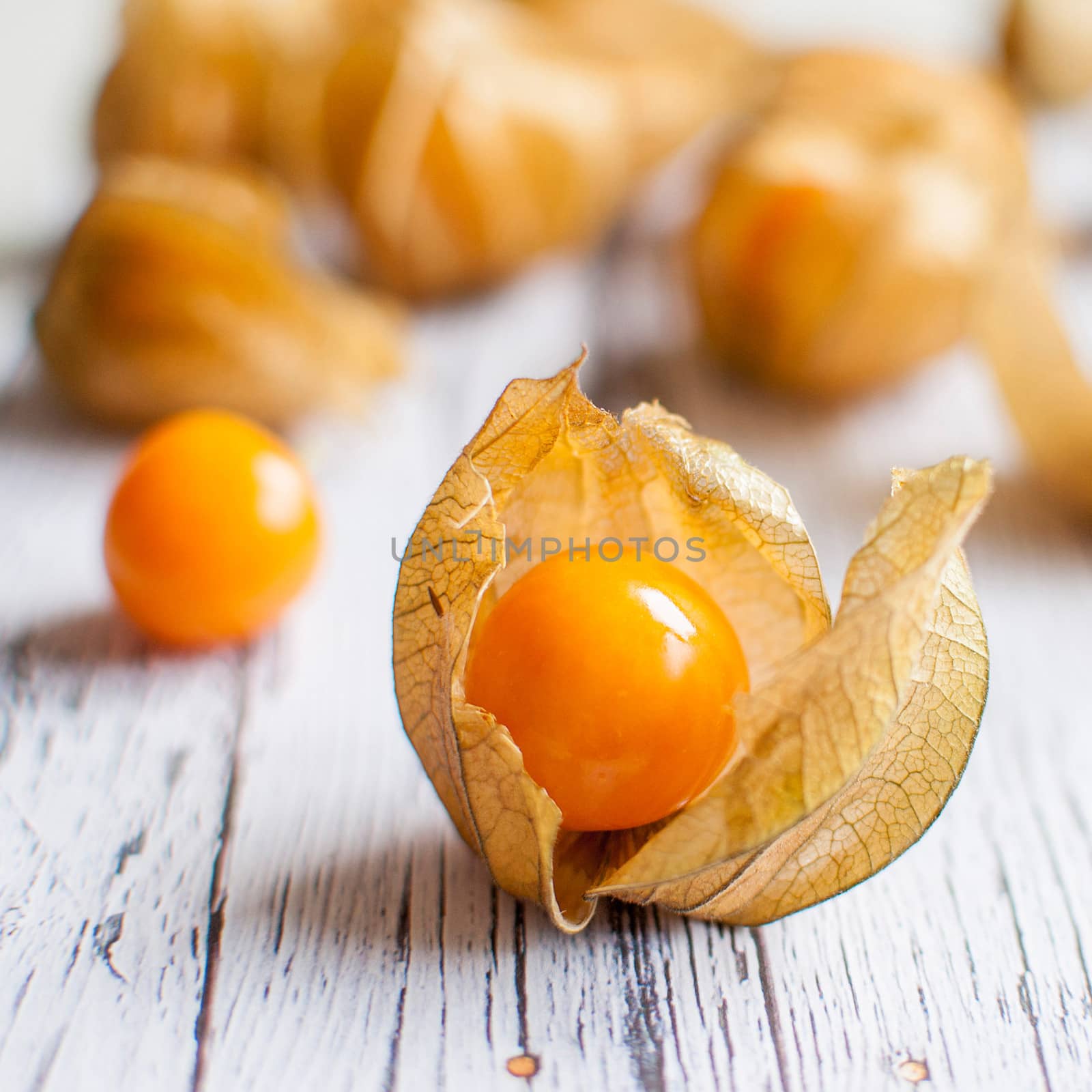 ripe healthy orange physalis over wooden board