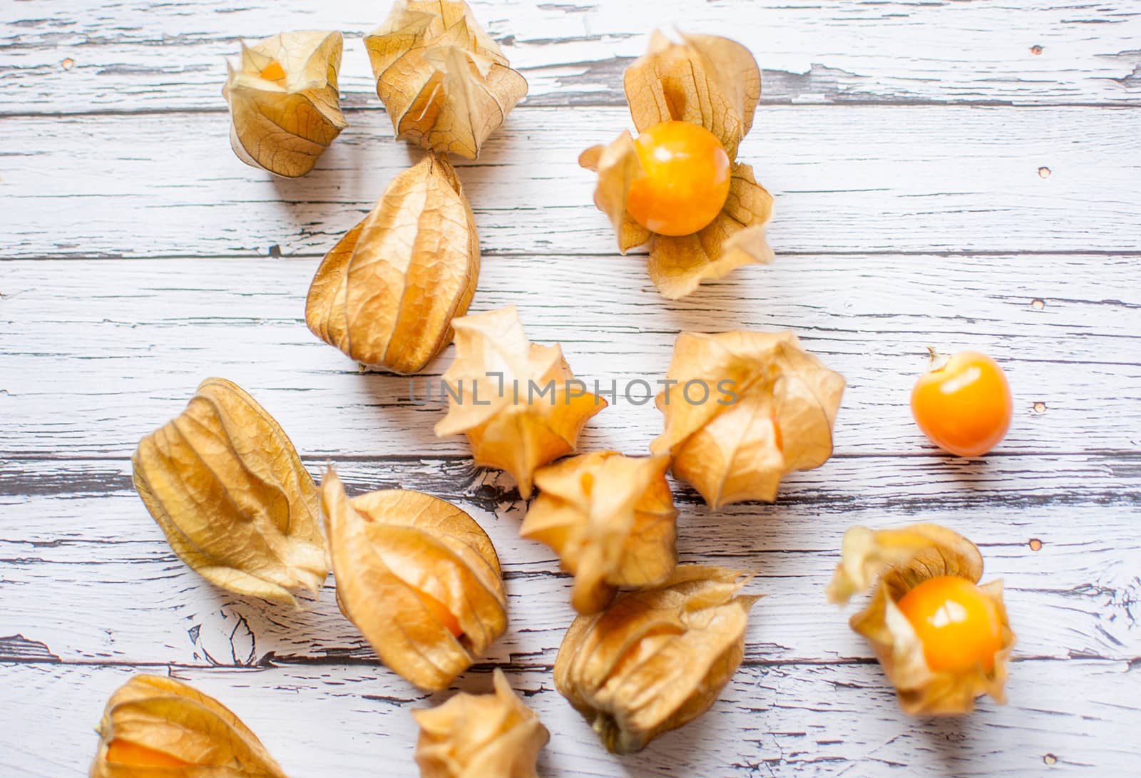 ripe healthy orange physalis over wooden board