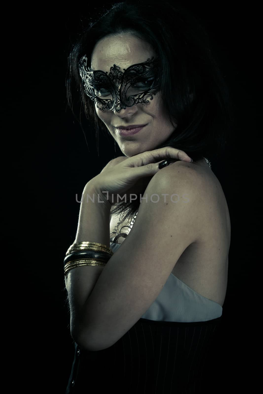Tribal.Beautiful young woman in mysterious black Venetian mask. Fashion photo. tribal design.
