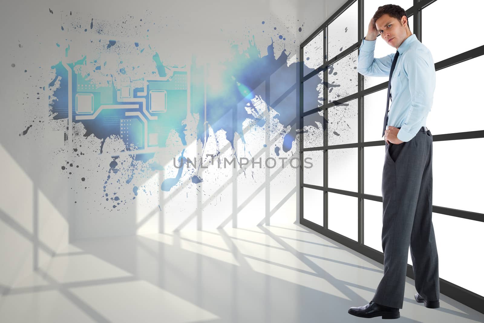 Thoughtful businessman with hand on head against splash showing technology interface