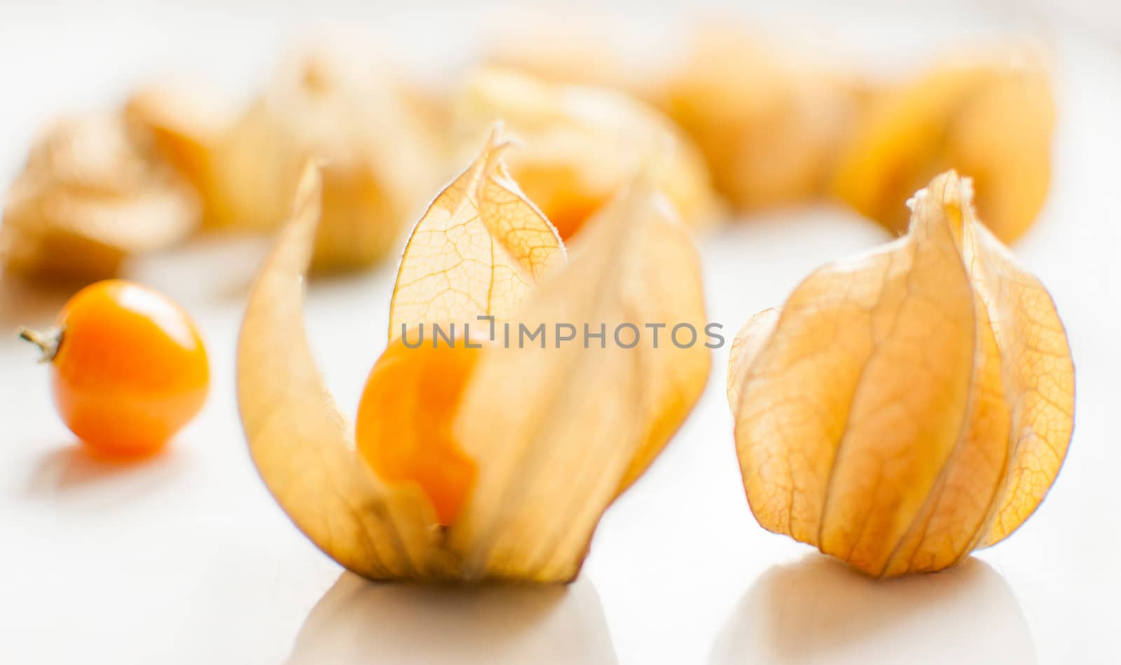 ripe healthy orange physalis over wooden board