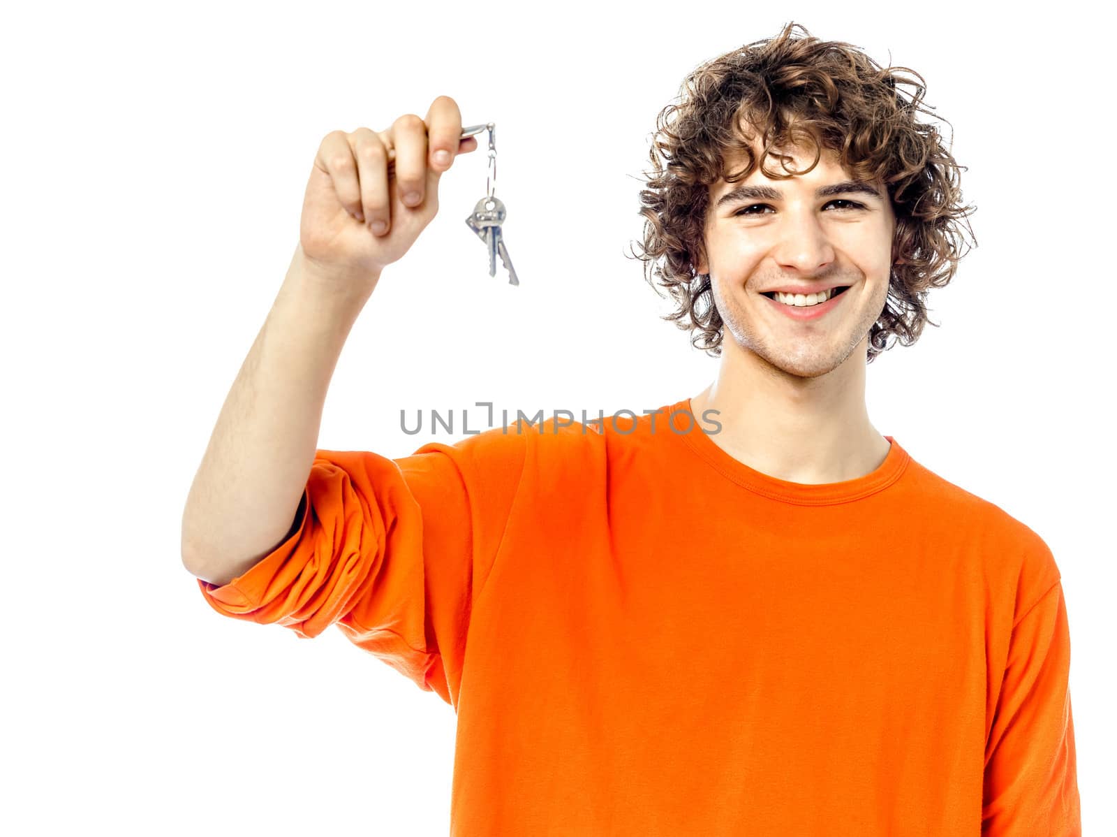 one young man caucasian holding keys portrait in studio white background