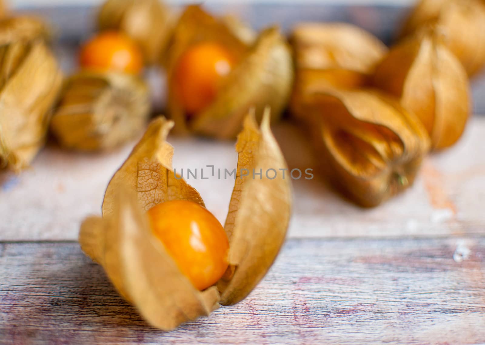 ripe healthy orange physalis over wooden board