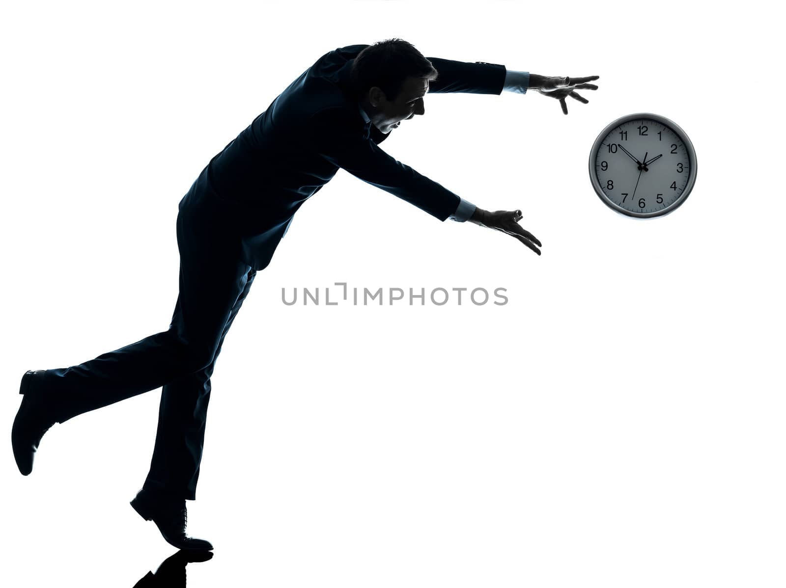 one caucasian businessman running after time in silhouette studio isolated on white background