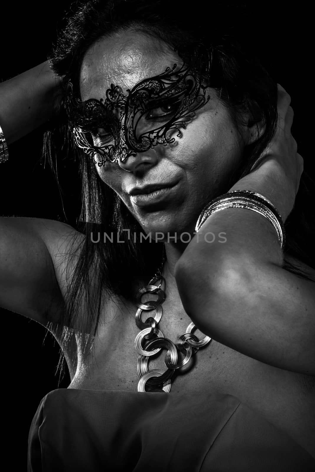Beautiful young woman in mysterious black Venetian mask. Fashion photo. tribal design.