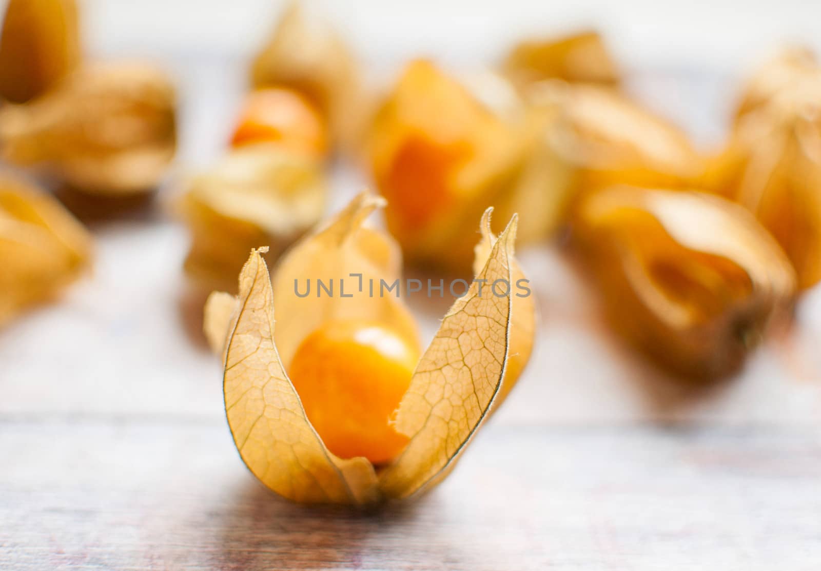 ripe healthy orange physalis over wooden board