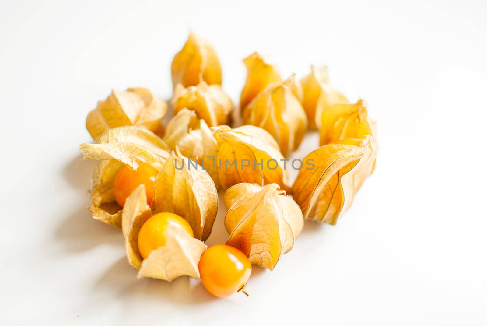 ripe healthy orange physalis over wooden board