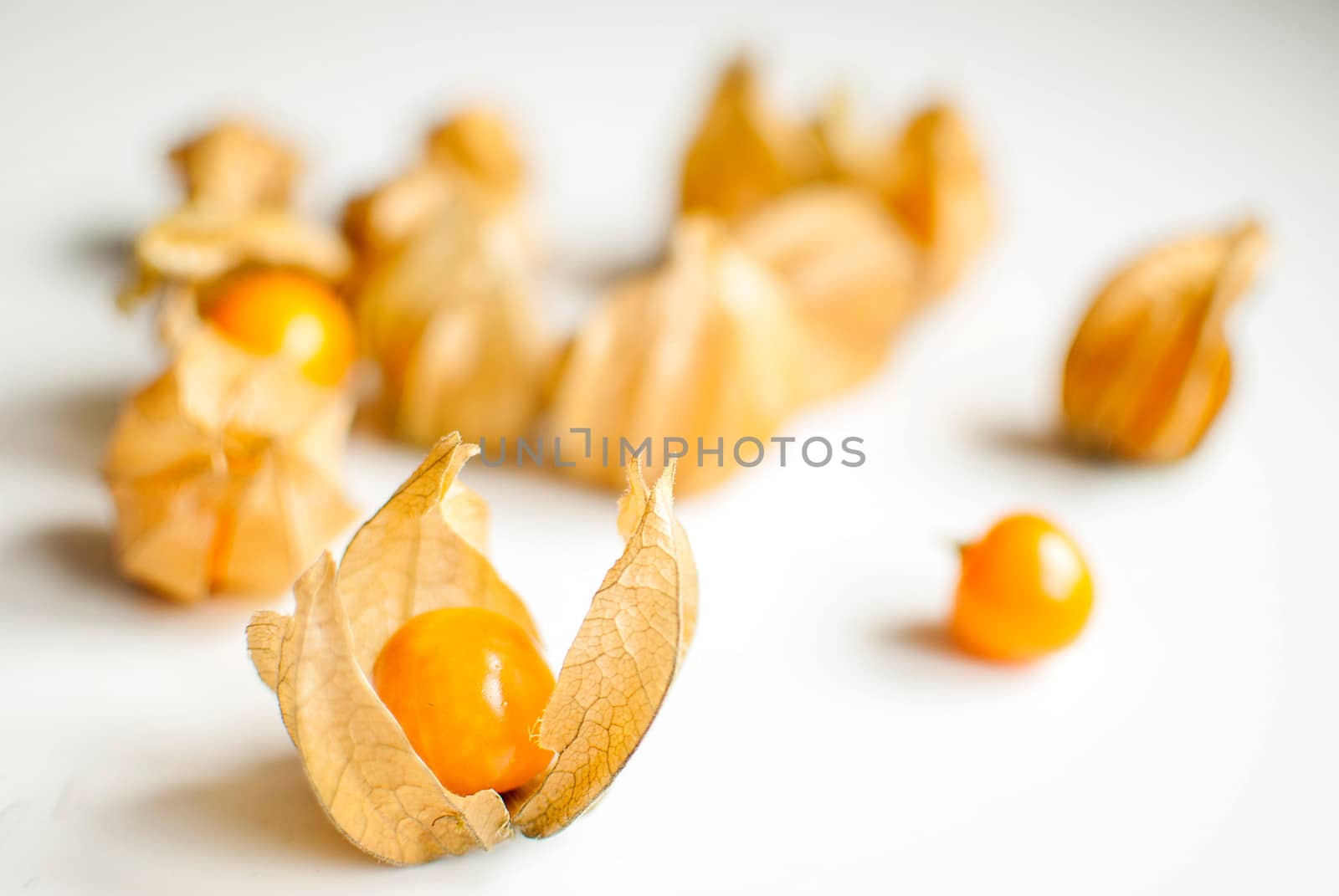 ripe healthy orange physalis over wooden board