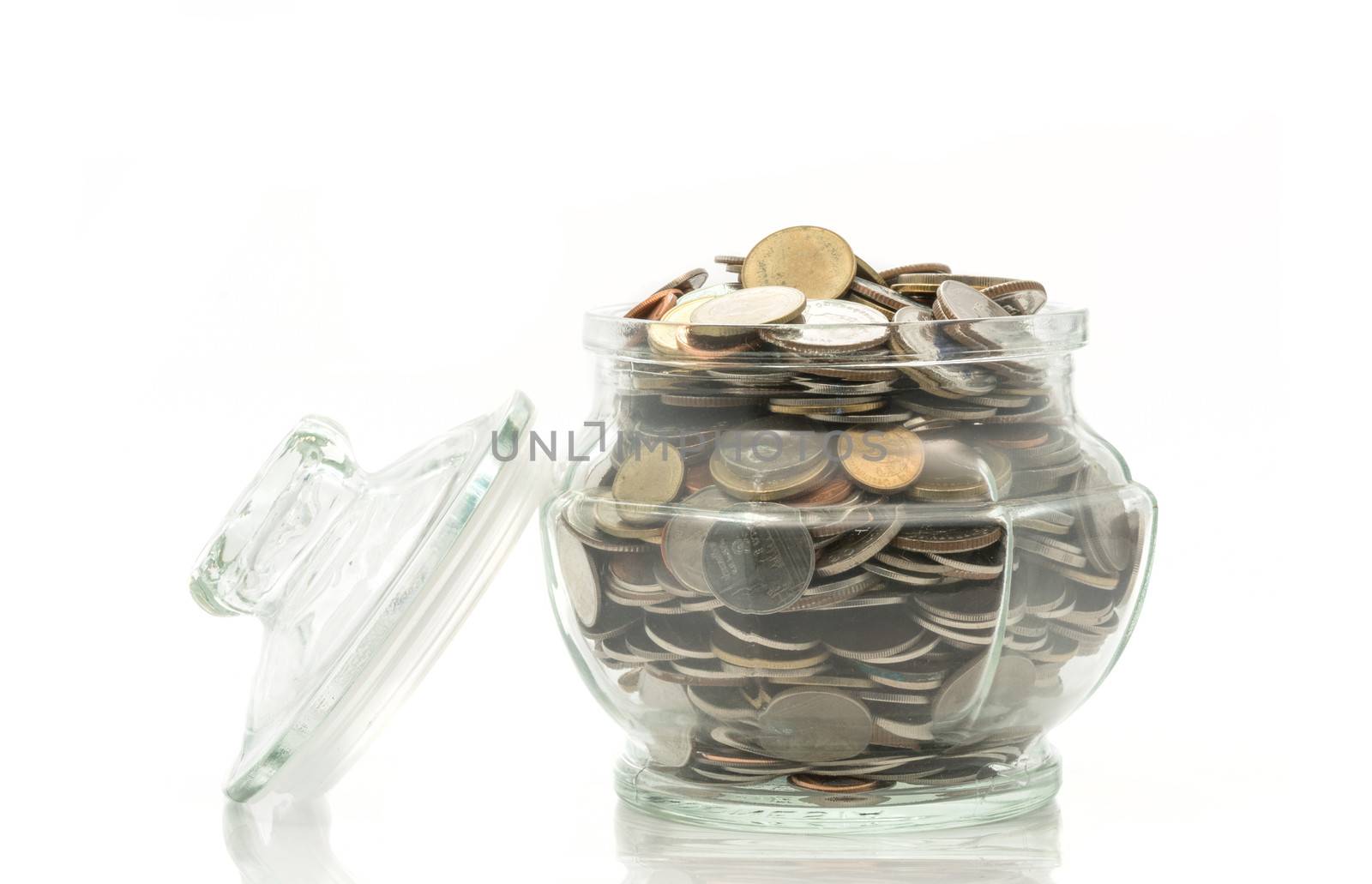 Bath coins in a glass jar with lid on white background