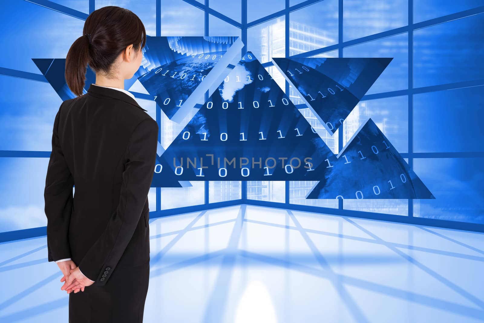 Businesswoman standing against binary code graphic on abstract screen in room